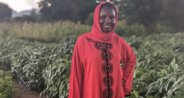 Woman in red dress in a field